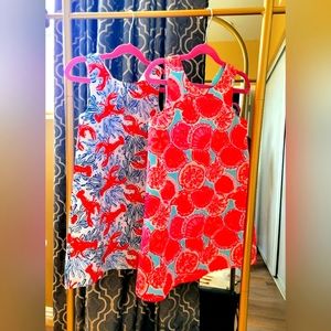 A pair of Tommy Bahamas baby dresses